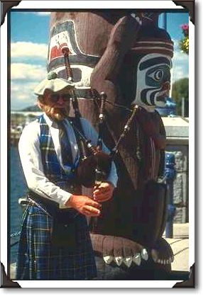Bagpiper and totem pole, Victoria, British Columbia