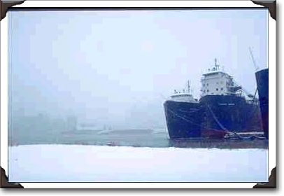 Ships in harbor in snowstorm