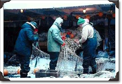 Repairing fish nets, deep sea trawler, Newfoundland