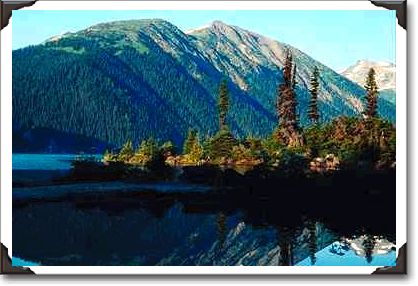 Reflection of mountains in a lake, British Columbia