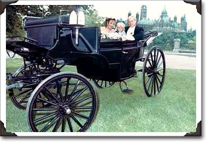 Bride and groom with little girl in a horse carriage