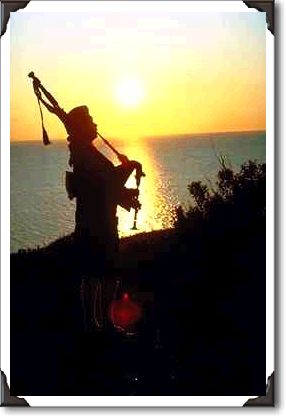 Highland piper at sunset, Nova Scotia